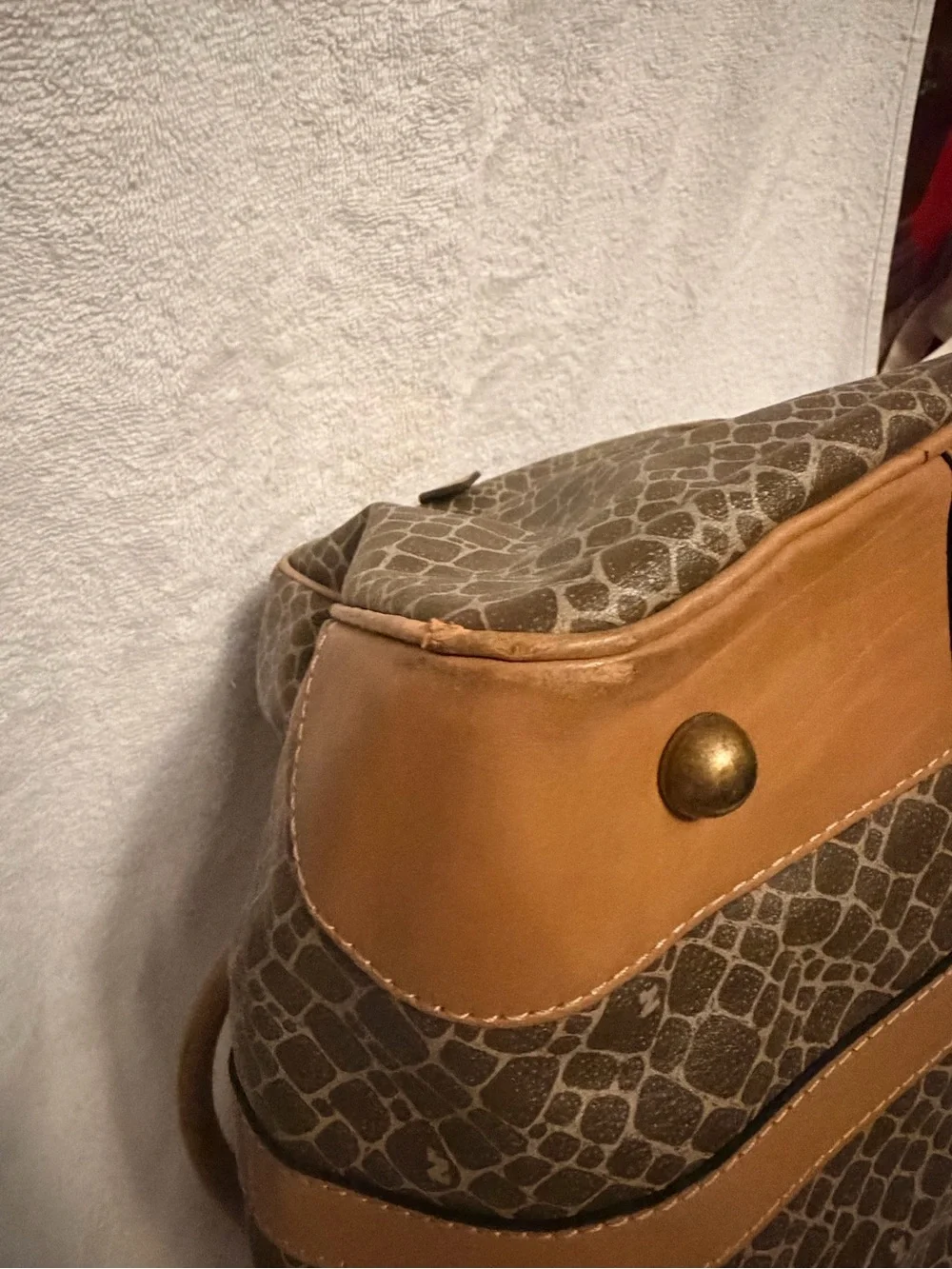 Nina Ricci Brown Patterned Duffel with Tan Trim. Has lock and key.